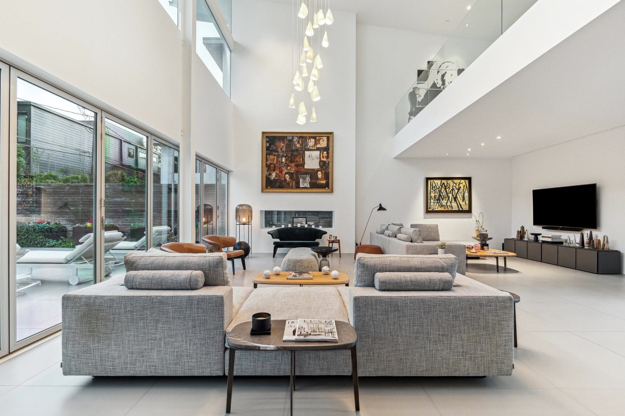 Two-story living room with art walls