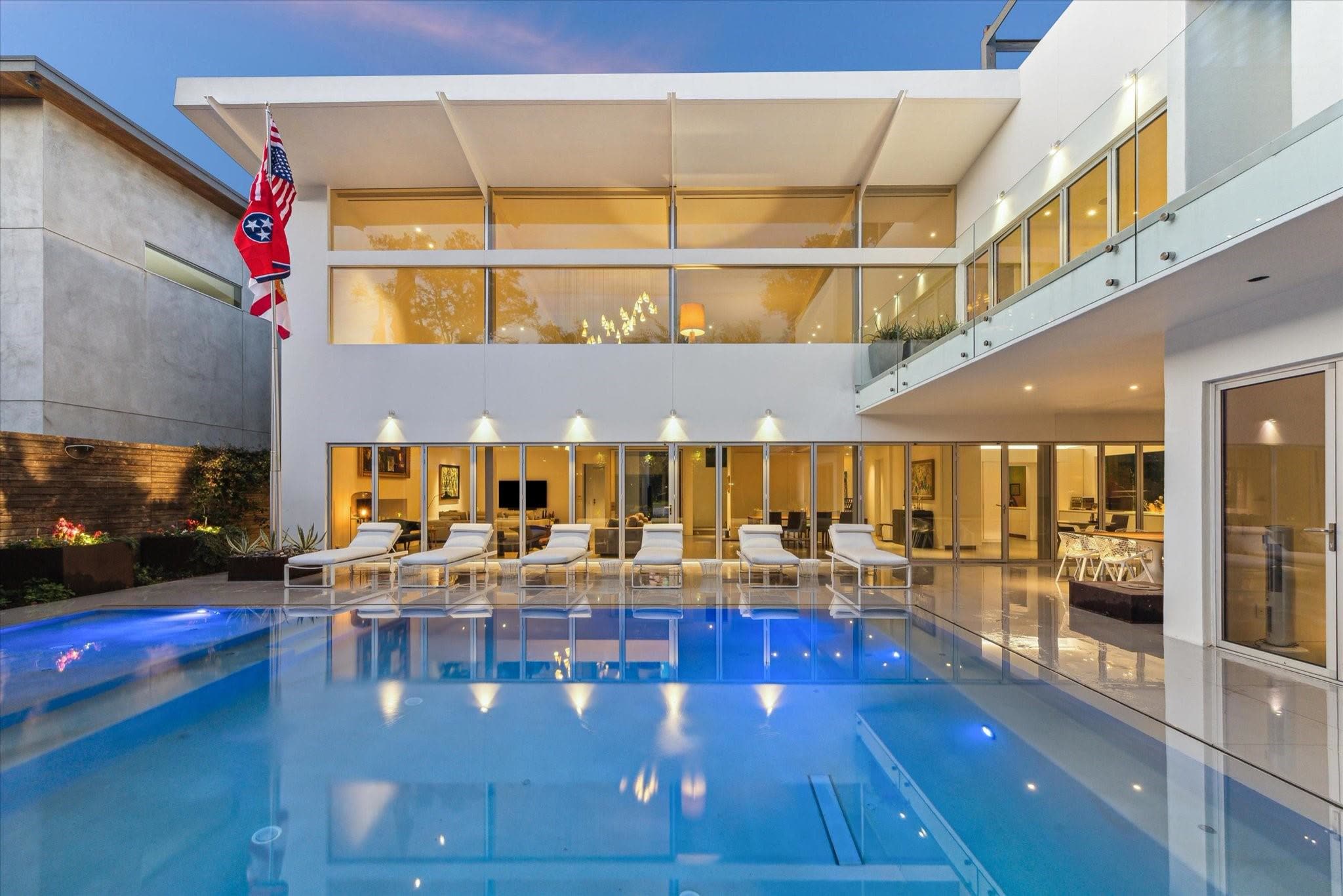 The pool and back of 2169 University Boulevard at dusk